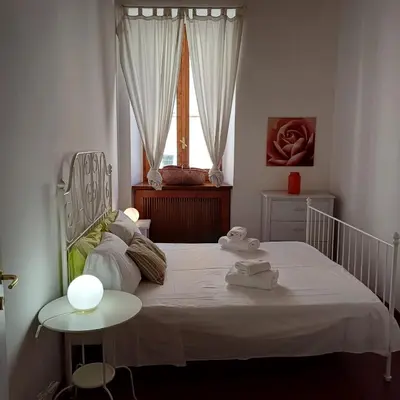 a bedroom with a white bed and a window at Conti Ripetta house in Rome