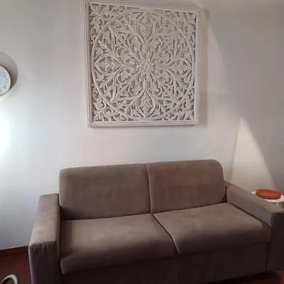 a couch in a living room with a picture on the wall at Conti Ripetta house in Rome
