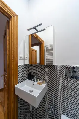 a bathroom with a white sink and a mirror at Flaminio District Holiday Home in Rome