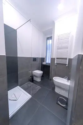 a bathroom with a shower and a toilet and a sink at Flaminio District Holiday Home in Rome