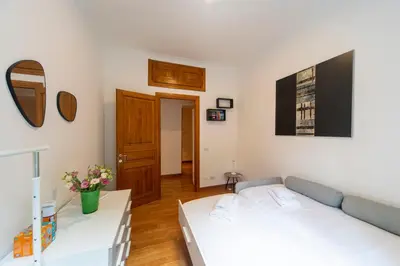 a living room with a bed and a couch at Flaminio District Holiday Home in Rome