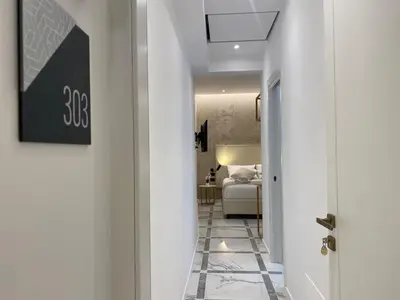 a hallway leading to a bedroom with a bed at Suite Croce in Rome