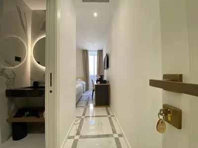 a hallway of a hotel room with a bedroom at Suite Croce in Rome