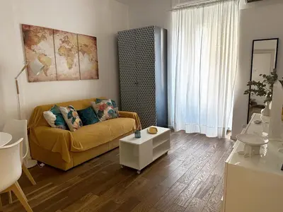 a living room with a couch and a table at Cheerful flat in funky Rome in Rome