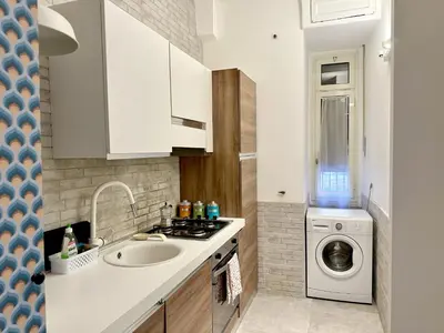 a kitchen with a sink and a washing machine at Cheerful flat in funky Rome in Rome