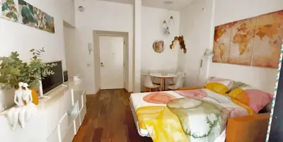 a bedroom with a bed and a tv in it at Cheerful flat in funky Rome in Rome