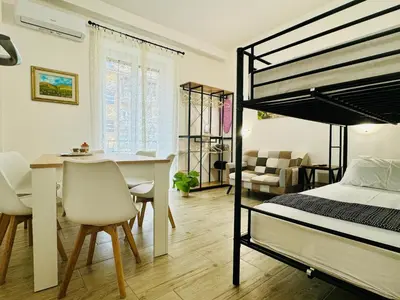 a bedroom with a bunk bed and a dining room at Casa Flora in Rome