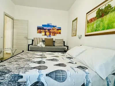 a bedroom with a large bed and a couch at Casa Flora in Rome