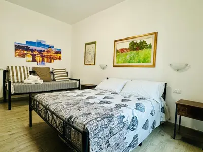 a bedroom with a bed and a couch at Casa Flora in Rome