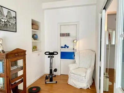 a living room with a chair and a camera at RomeAsYouLike - Trastevere Experience 20 in Rome