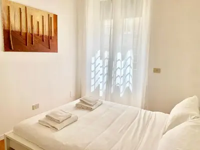 a white bed with two towels on top of it at RomeAsYouLike - Trastevere Experience 20 in Rome