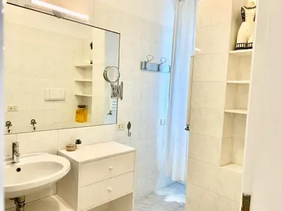 a white bathroom with a sink and a shower at RomeAsYouLike - Trastevere Experience 20 in Rome