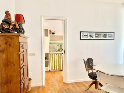 a white room with a table and a chair at RomeAsYouLike - Trastevere Experience 20 in Rome