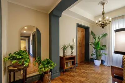 a hallway with potted plants and a mirror at Daplace - Lavinia Apartment in Rome