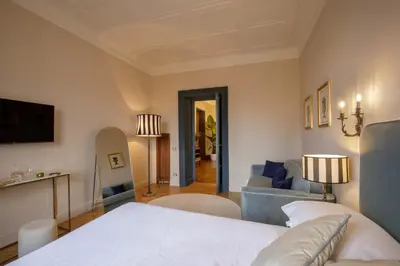 a bedroom with a bed and a living room at Daplace - Lavinia Apartment in Rome