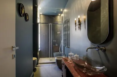 a bathroom with a sink and a toilet and a shower at Daplace - Lavinia Apartment in Rome
