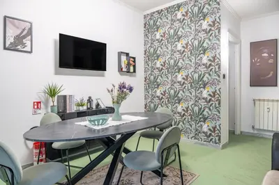 a dining room with a table and chairs at Domus Farnesina Ponte Milvio in Rome