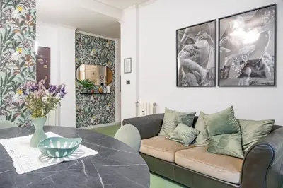 a living room with a couch and a table at Domus Farnesina Ponte Milvio in Rome