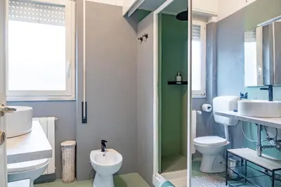 a bathroom with a toilet and a sink and a shower at Domus Farnesina Ponte Milvio in Rome