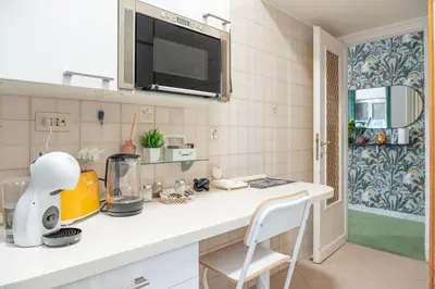 a kitchen with a white counter top in a room at Domus Farnesina Ponte Milvio in Rome