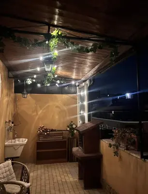 a bathroom with a tub and a sink with lights at Green Holiday Penthouse in Rome