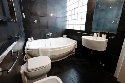 a bathroom with a white toilet and a sink at Villa Aureliana with pool near San Peter in Rome