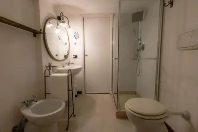 a bathroom with a toilet and a sink and a shower at Villa Aureliana with pool near San Peter in Rome