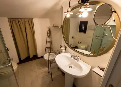 a bathroom with a sink and a mirror at Villa Aureliana with pool near San Peter in Rome