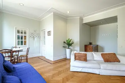 a living room with a white couch and a table at PIRAMIDE SHABBY by Casa e Lode - colosseum, air conditioning in Rome