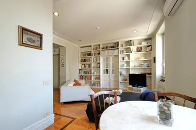 a living room with a couch and a table and a television at PIRAMIDE SHABBY by Casa e Lode - colosseum, air conditioning in Rome