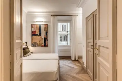 a white room with a bed and a window at Essenze eleganti a Trastevere in Rome