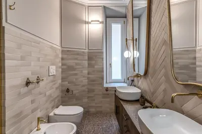 a bathroom with two sinks and a mirror at Essenze eleganti a Trastevere in Rome