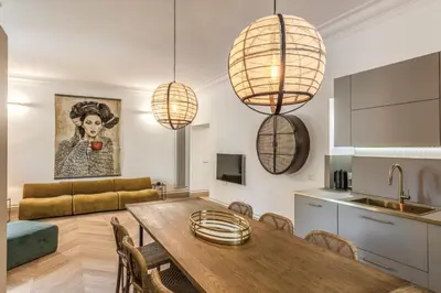 a kitchen and living room with a table and chairs at Essenze eleganti a Trastevere in Rome
