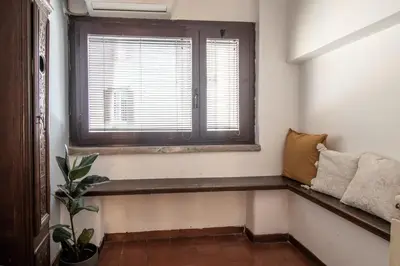 a window seat in a room with a plant at Suite Benedetta - Trastevere Luxury in Rome