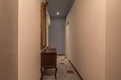 a hallway with a dresser and a mirror on a wall at Suite Benedetta - Trastevere Luxury in Rome