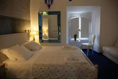a bedroom with a bed with a mirror and a chair at Vatican Leone IV in Rome