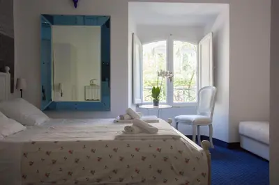 a bedroom with a bed with a mirror and a chair at Vatican Leone IV in Rome