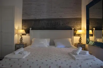 a bedroom with a large bed with two towels on it at Vatican Leone IV in Rome