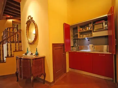 a kitchen with red cabinets and a sink at Domus Navona Pantheon in Rome