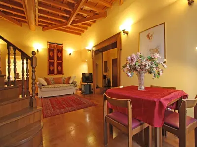 a living room with a table with a vase of flowers on it at Domus Navona Pantheon in Rome