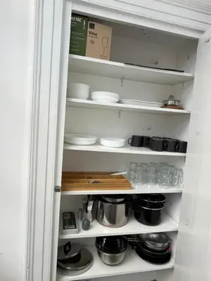 a kitchen pantry with plates and bowls and dishes at Roma Stazione Termini 300 mq appartamento con 4 camere vista e idromassaggio in Rome