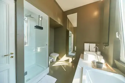 a bathroom with a shower and a sink and a toilet at Roma Stazione Termini 300 mq appartamento con 4 camere vista e idromassaggio in Rome
