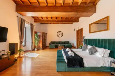 a large living room with a bed and a couch at Appartamento con vista piazza Navona in Rome