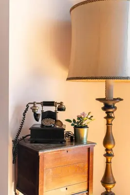 an old telephone sitting on a table next to a lamp at Appartamento con vista piazza Navona in Rome