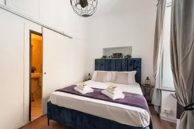 a bedroom with a bed with towels on it at Appartamento con vista piazza Navona in Rome