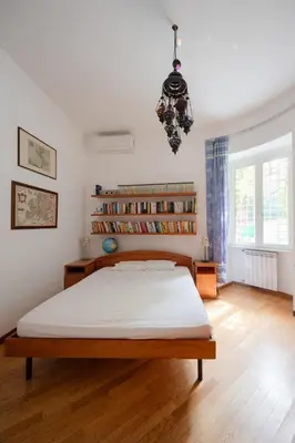 a bedroom with a large bed and a book shelf at Francesco Terrace - Piazza Bologna, Rome in Rome