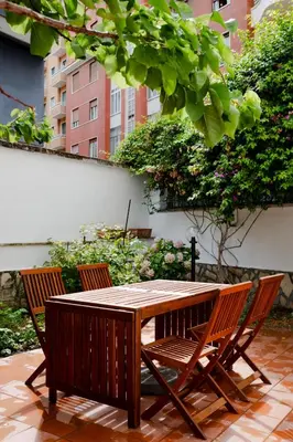 a wooden table with three chairs around it at Francesco Terrace - Piazza Bologna, Rome in Rome