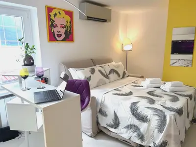 a bedroom with a bed and a desk with a laptop at Fornaci 8 - Loft in Vatican in Rome