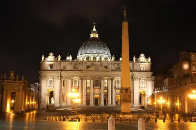 a large building with a tower in front of it at night at Fornaci 8 - Loft in Vatican in Rome