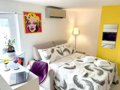 a bedroom with a bed and a laptop on a table at Fornaci 8 - Loft in Vatican in Rome